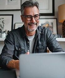 wesmcdowell happy middle aged man looking at his laptop in nice f56f1a6b 9518 42d8 a75f dcffb8ca291d 1.webp